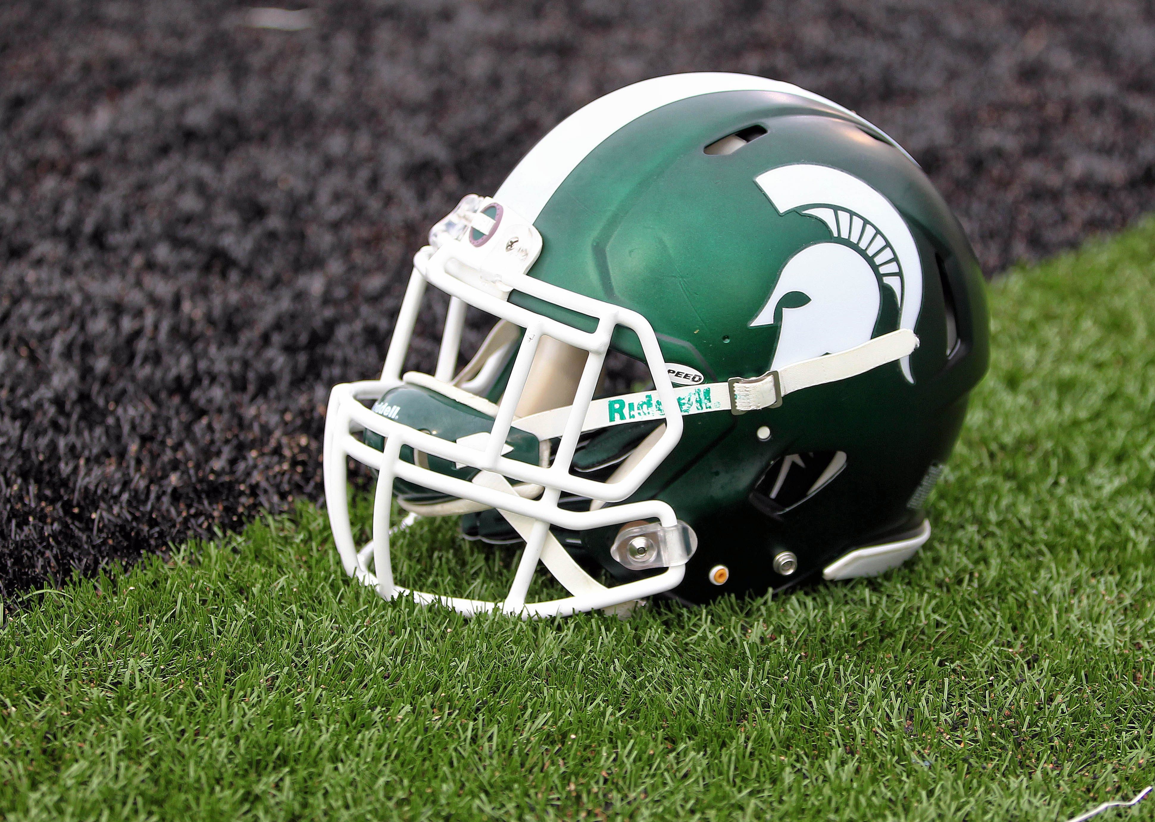A Michigan State Spartans helmet on field.